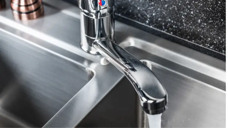 Should you use hot or cold water when running a garbage disposal? 